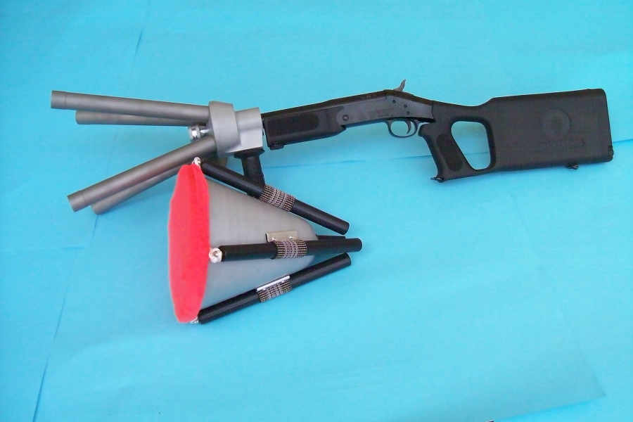 Ace Capture canister-switch net gun with long stock, next to a loaded canister