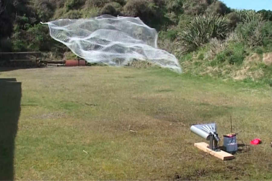 Ace Capture mounted horizontal-launching pigeon net gun with net in flight