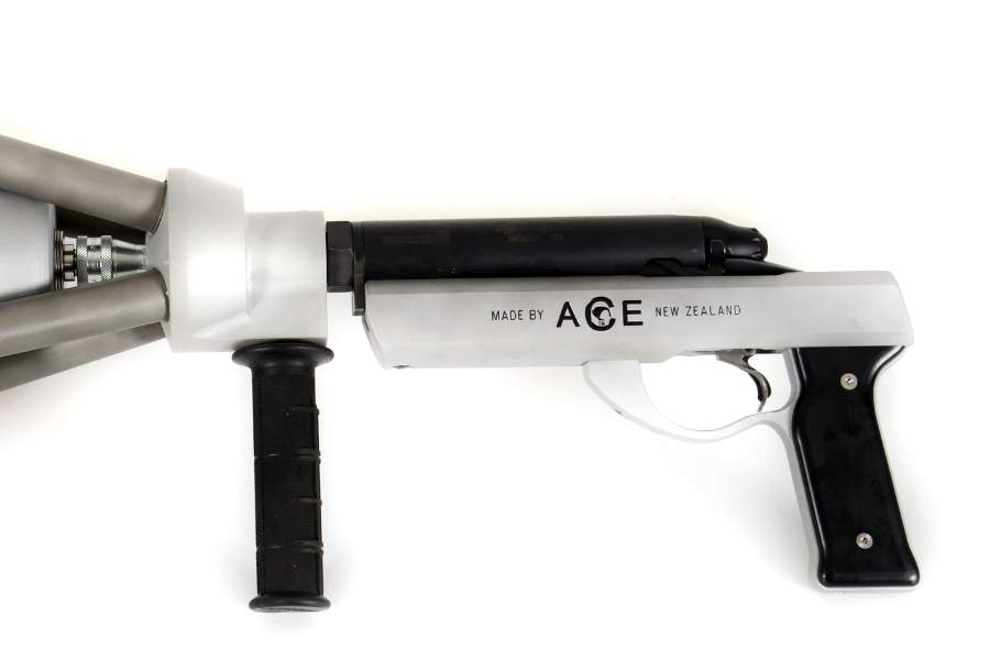 Handheld canister-switch net gun with short stock, showing action